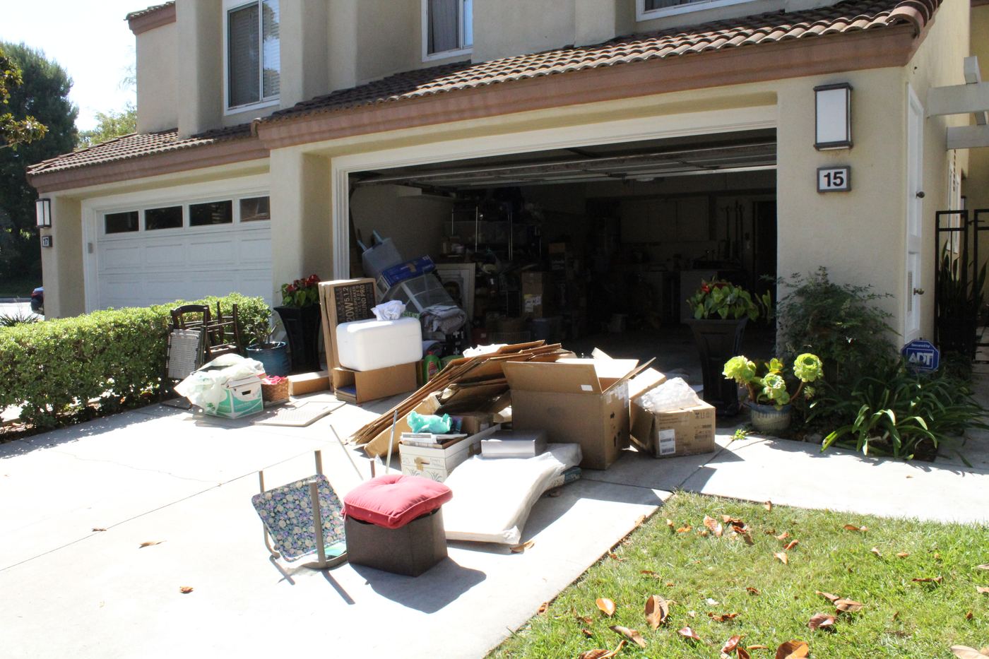 Driveway pile of boxes and furniture staged for a Blackstone Junk Removal pickup