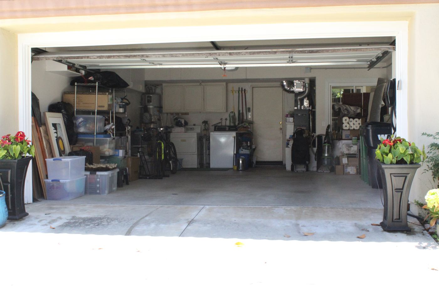Garage packed with boxes and storage before Blackstone Junk Removal cleared it out